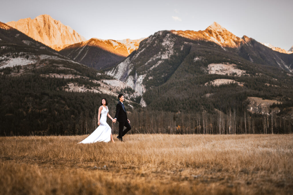 Bride and Groom walking on the Airstrip during sunset in Jasper